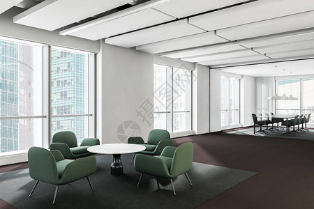 现代办公室等候室内部有白色墙壁圆咖啡桌附近的绿色扶手椅和背景玻璃墙会议室3天翻背景图片