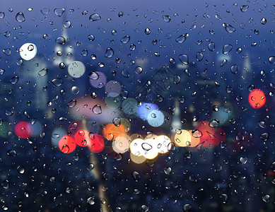 雨夜景玻璃水珠前的光斑设计图片