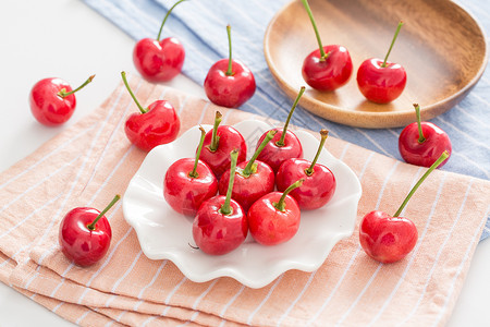 红色盘子一些樱桃放在桌布上背景