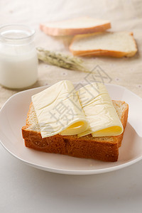 芝士蛋糕食材早餐黄油面包和牛奶背景
