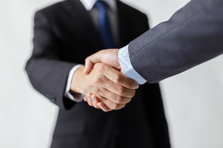 商务人士握手合作握手的商务人士背景