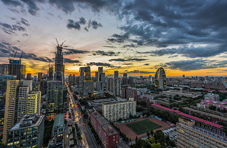 远山城市夕阳下的北京cbd背景