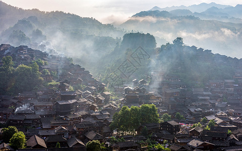 世界建筑日字体西江苗寨晨烟背景