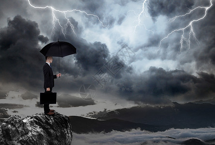 士气低落打伞站在山崖上商务男士背景图设计图片