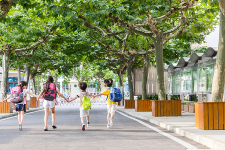 上学背影孩子们牵手快乐奔跑的背影背景