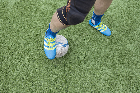 足球比赛鞋子足球运动员在草坪上训练踢球背景