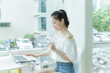 咖啡馆女生手拿水看电脑学习高清图片