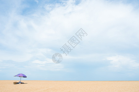 沙滩与天空一把紫色的伞高清图片