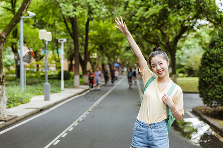 挥手的女孩校园女生挥手背景