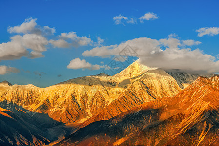 藏族装饰贡嘎雪山金色阳光美景背景