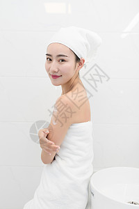 洗完澡在护肤的年轻美女背景