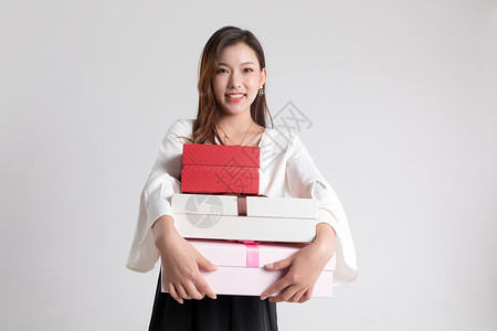 买包打折年轻女性抱着礼物盒背景