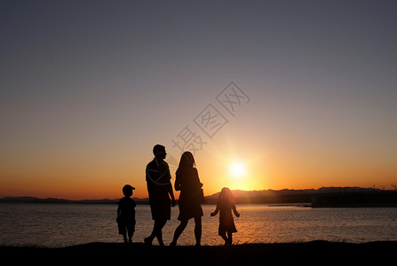 人物手拉手夕阳下的家庭剪影设计图片