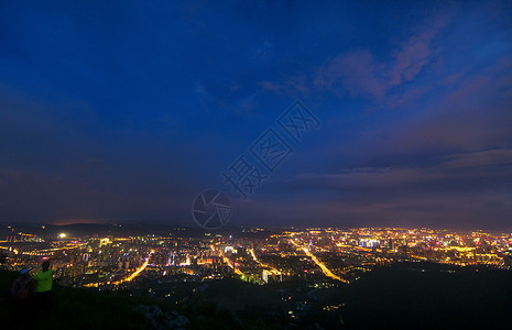 蓝色粒子线条昆明新城城市夜景背景