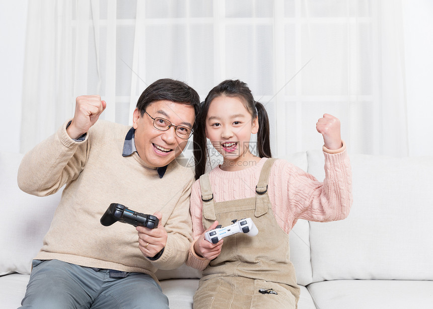 爷爷和孙女在沙发玩游戏图片