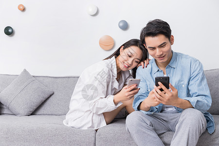 年轻情侣开心看手机亚洲人高清图片素材