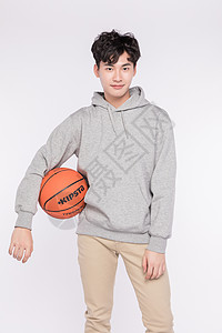 打篮球男子拿着篮球的帅气年轻男子背景