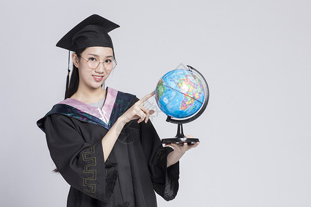 教育目标拿着地球仪的毕业女大学生背景