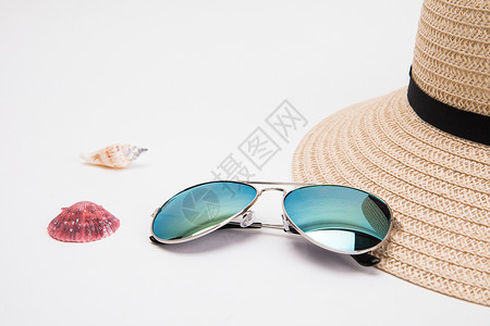 粉红贝壳眼镜和草帽背景