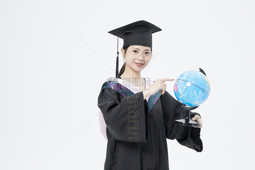 拿着地球仪的毕业女大学生图片