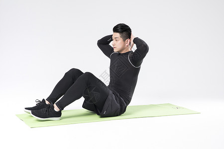 腹肌训练仰卧起坐的运动男性背景
