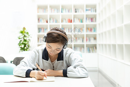 女生毕业高中生书桌听音乐学习背景