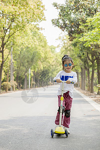 玩滑板车女孩女孩在玩滑板车背景