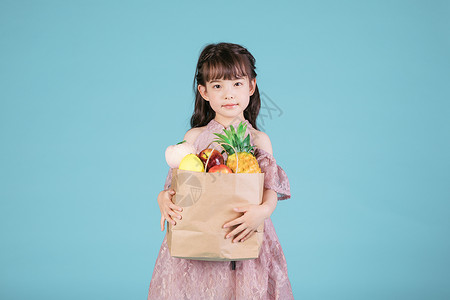 小女孩儿童节手持一袋水果图片