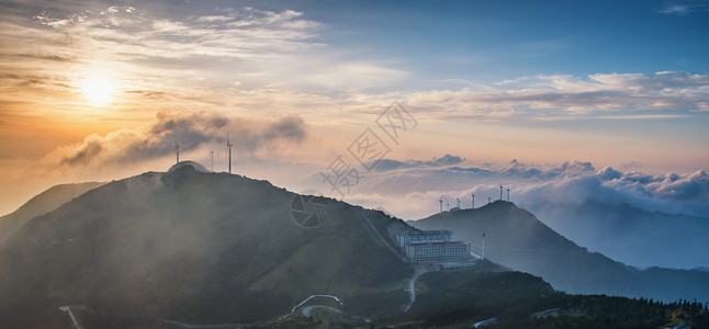 环保能源风电机山顶日出云海全景背景