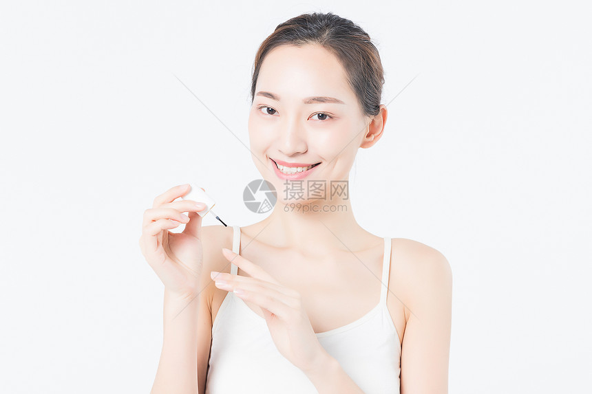 女性美甲涂指甲保护油特写图片