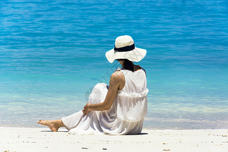 沙巴沙滩坐着的海滩美女背影背景