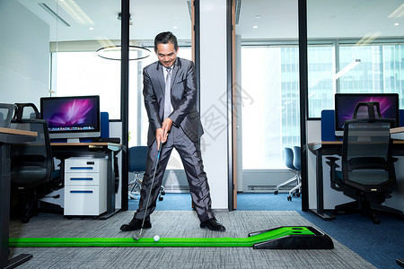 商务男士办公室打高尔夫背景图片