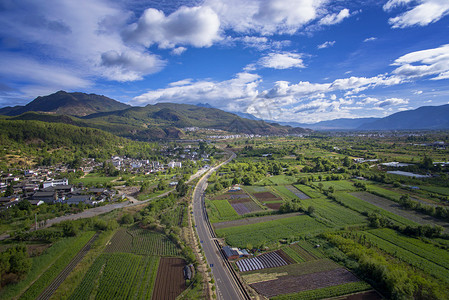 城市植被大气丽江雪山城市田野航拍背景