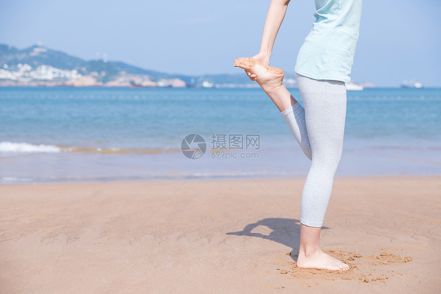 海边运动女性热身特写图片