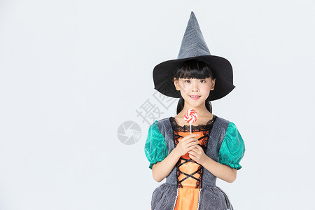 可爱小女孩万圣节女巫打扮拿着棒棒糖图片