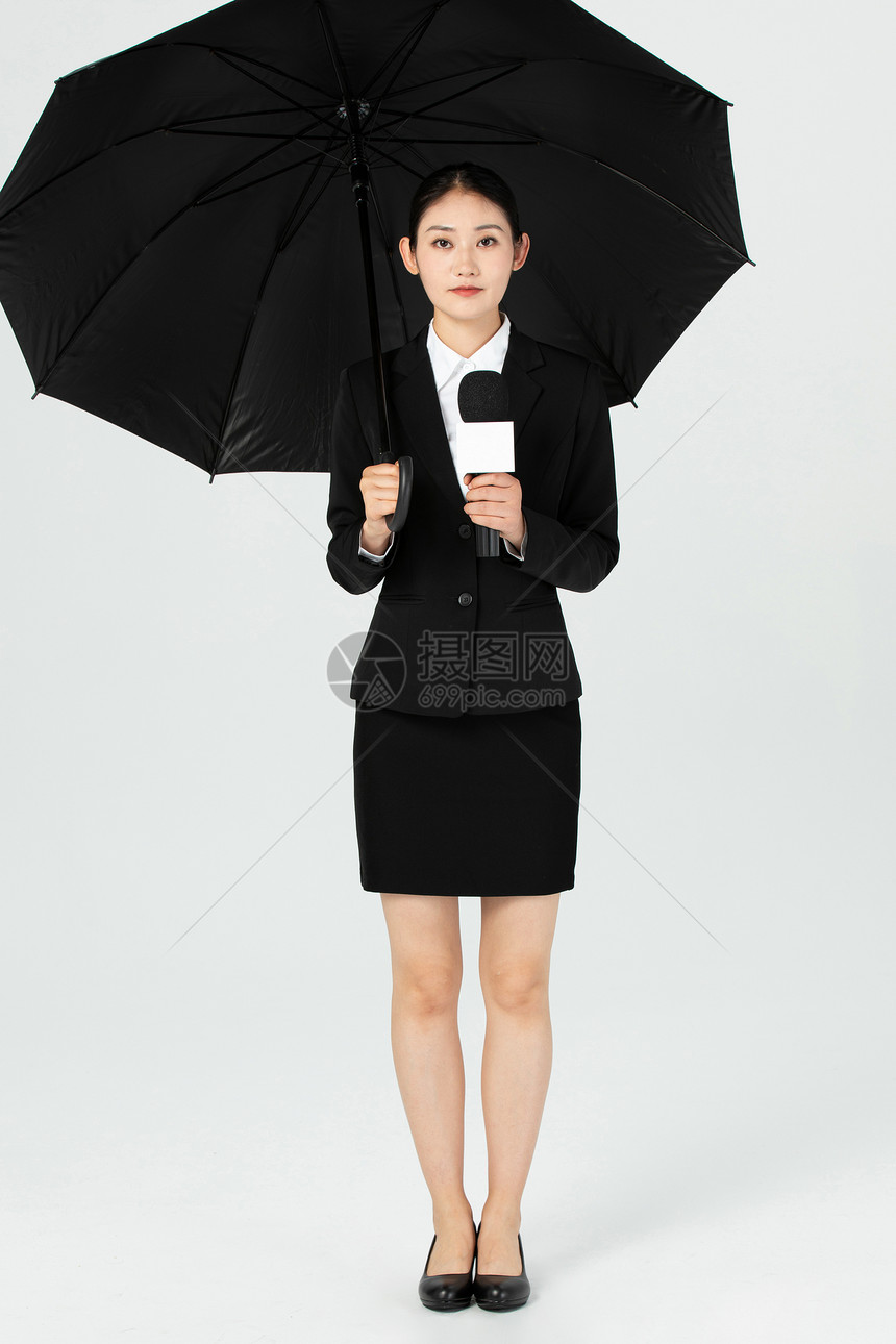 女性年轻记者打伞采访图片