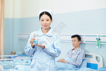医院里药瓶女护士手拿药瓶展示背景