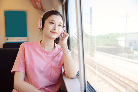 青年女性坐在高铁上听歌亚洲人高清图片素材