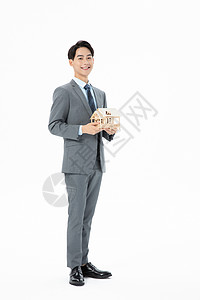 青年商务男性抱着房子模型职业高清图片素材
