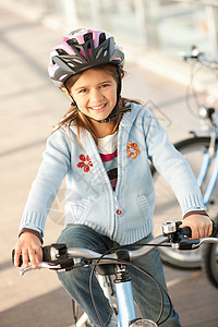 城市隧道骑自行车的女孩头盔高清图片素材