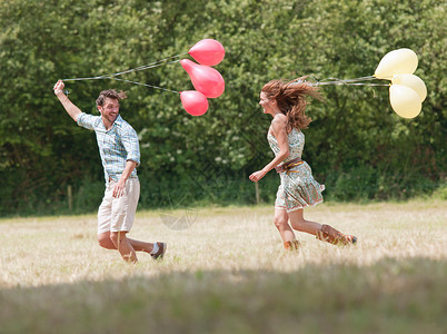 情侣牵气球奔跑追逐图片