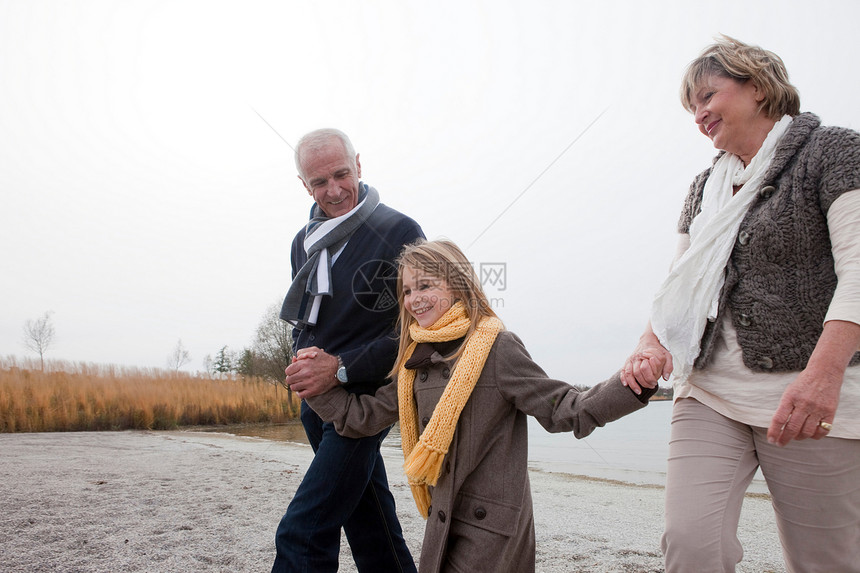 祖父母和女孩在湖边散步图片
