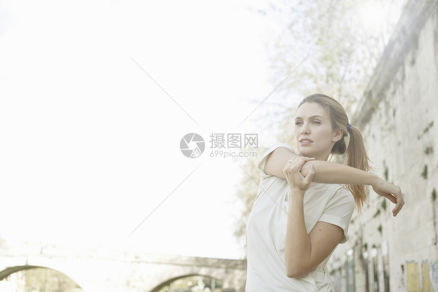 年轻女子在运动前伸展手臂图片