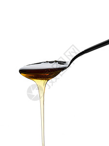 蜂蜜从勺子里倒出图片