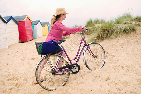 推自行车的女人帽子高清图片素材