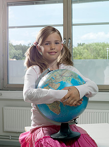 抱着地球仪的女孩图片