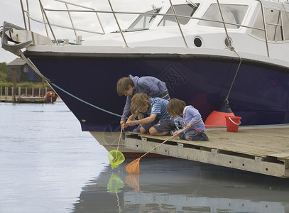 背着渔网的男孩孩子们乘船钓鱼背景