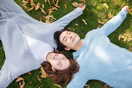 秋天情侣躺在草地上爱情高清图片素材