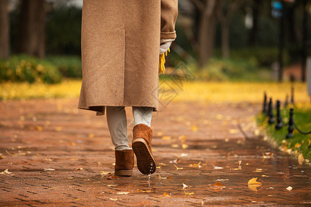 雨季少女下雨天美女公园里散步脚步特写背景