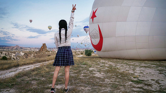 乘坐热气球土耳其卡帕多奇亚热气球体验的马尾女孩背影背景